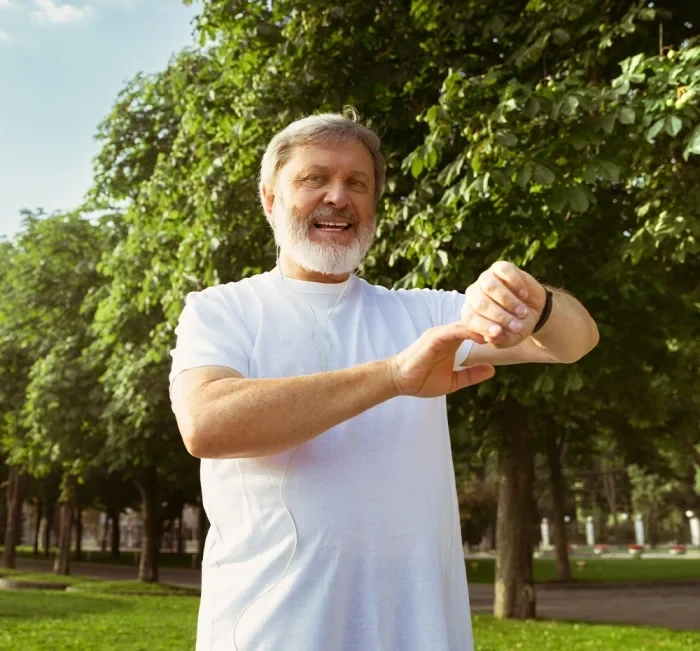 An older man exercising outdoors